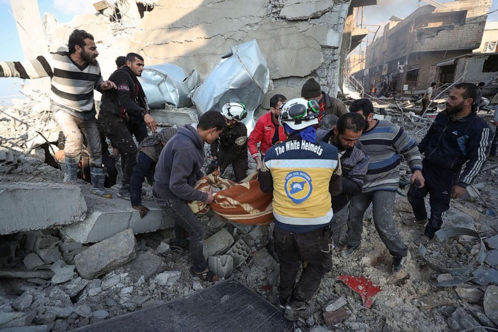 PHOTO: Members of the Syrian Civil Defense known as White Helmets and locals carry a victim after a reported Russian airstrike on a popular market in the village of Balyun in Syria's northwestern Idlib province, Dec. 7, 2019.