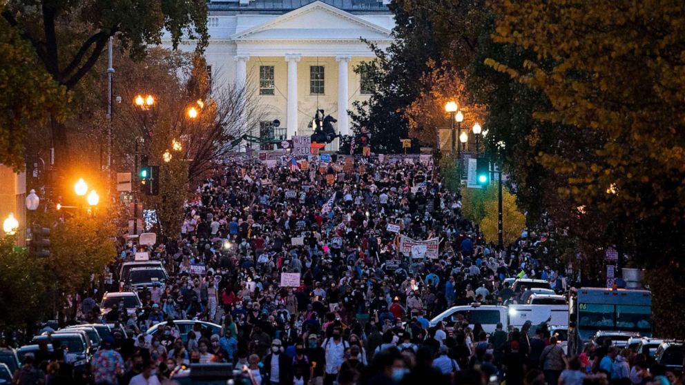 PHOTO: People gather in Black Lives Matter Plaza near the White House as they celebrate after Democratic nominee Joe Biden was declared winner of the 2020 presidential election on Nov. 7, 2020 in Washington, DC.