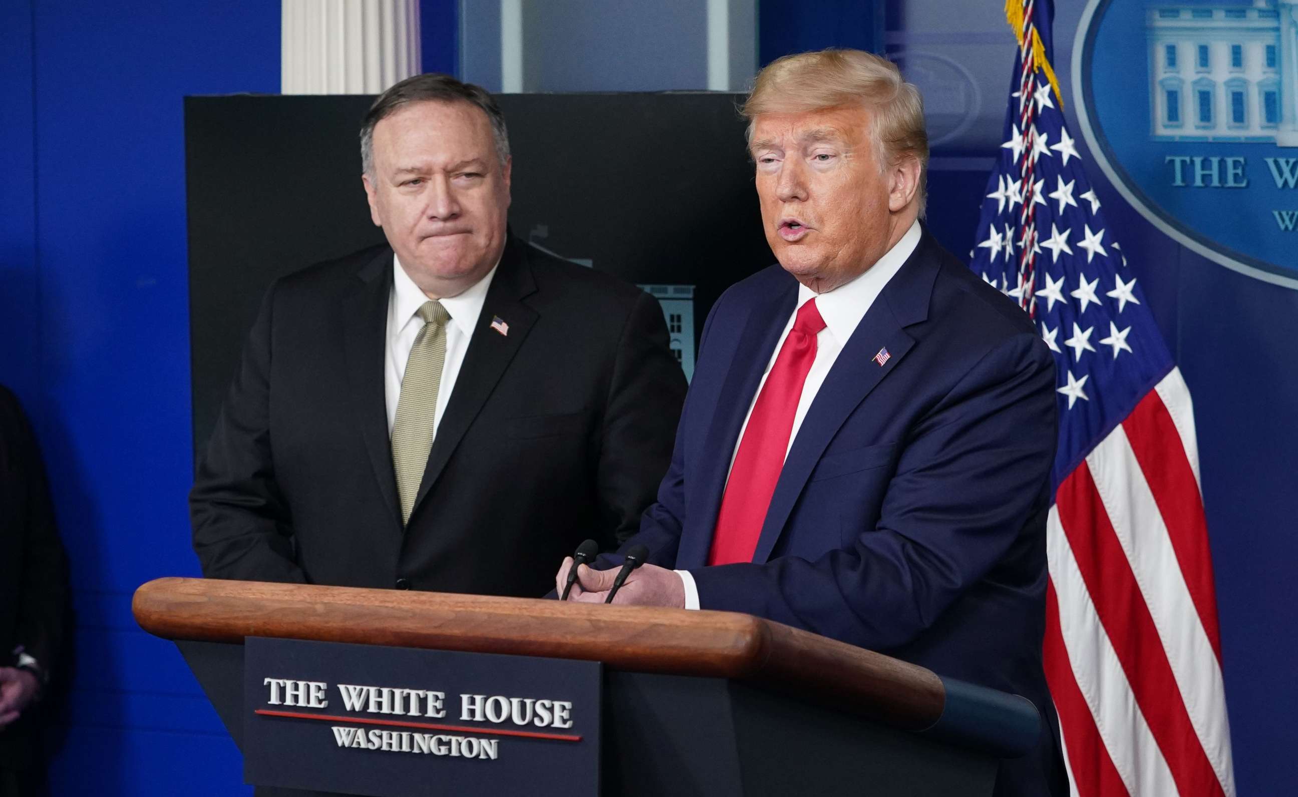 PHOTO: Secretary of States Mike Pompeo watches President Donald Trump speak during the daily briefing on the novel coronavirus, COVID-19, in the Brady Briefing Room at the White House on April 8, 2020, in Washington.