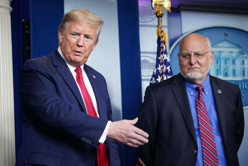 PHOTO: President Donald Trump and CDC Director Robert R. Redfield participate in the daily briefing on the novel coronavirus in the Brady Briefing Room of the White House on April 22, 2020, in Washington.
