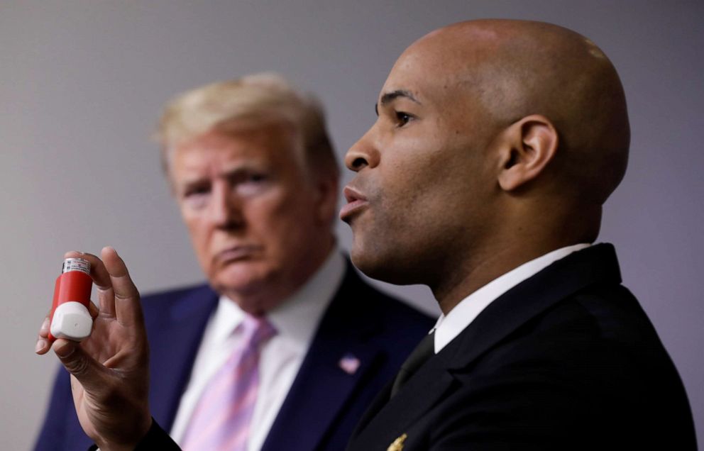 PHOTO: Surgeon General Jerome Adams holds up his asthma inhaler as President Donald Trump watches during the coronavirus response daily briefing at the White House in Washington, April 10, 2020.