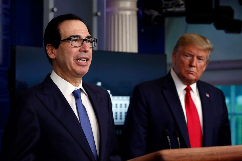 PHOTO: President Donald Trump listens as Treasury Secretary Steven Mnuchin speaks in the James Brady Press Briefing Room at the White House, Monday, April 13, 2020, in Washington.