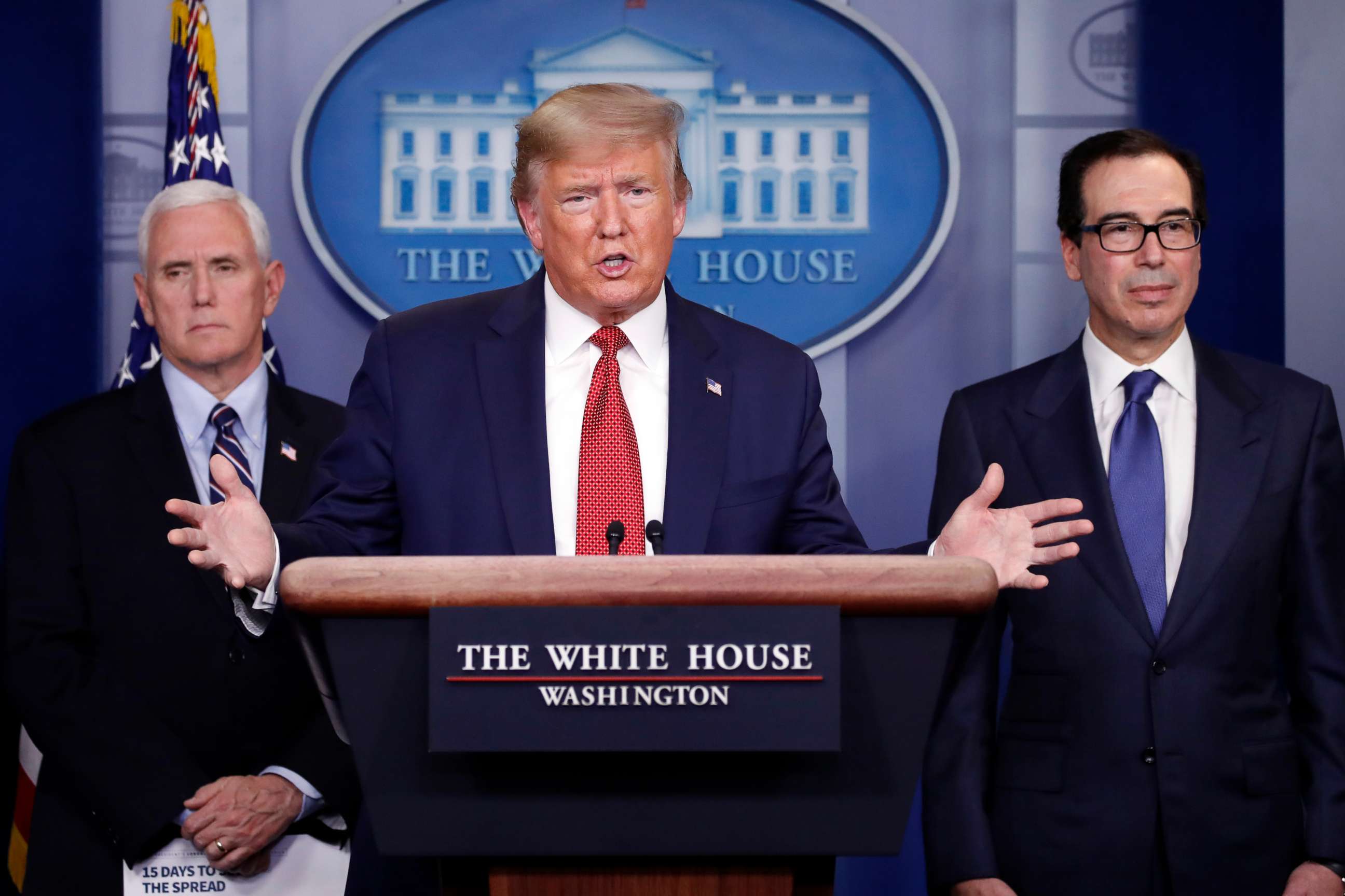 PHOTO: President Donald Trump speaks about the coronavirus in the James Brady Briefing Room, March 25, 2020, in Washington, as Vice President Mike Pence and Treasury Secretary Steven Mnuchin listen.