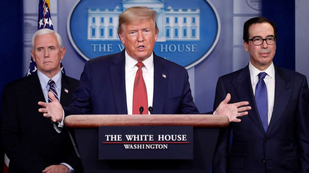 PHOTO: President Donald Trump speaks about the coronavirus in the James Brady Briefing Room, March 25, 2020, in Washington, as Vice President Mike Pence and Treasury Secretary Steven Mnuchin listen.