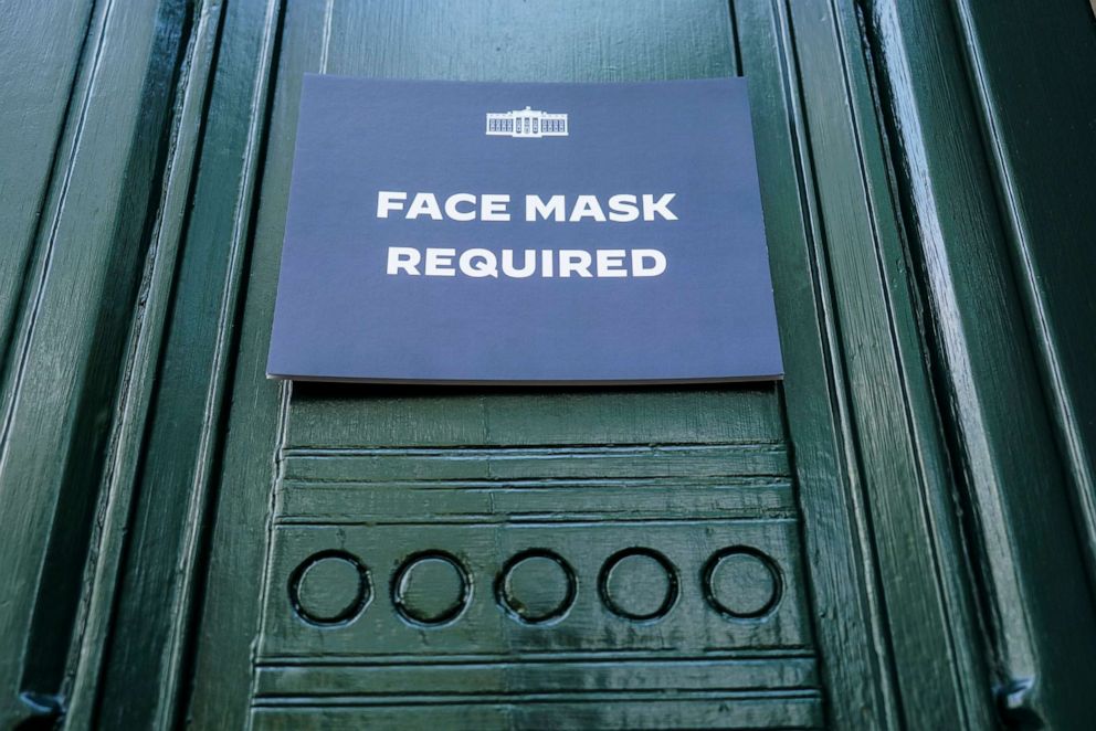 PHOTO: A sign requiring the wearing of face masks is displayed at the testing center for visitors to the White House on July 30, 2022 in Washington.