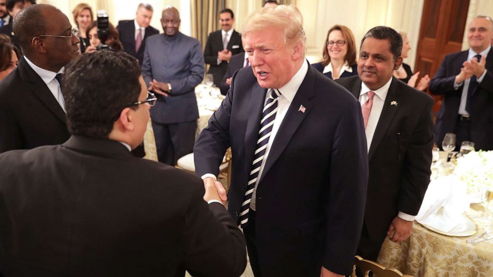 PHOTO: President Donald Trump greets guests while hosting an Iftar dinner in the State Dining Room at the White House, June 6, 2018, in Washington.