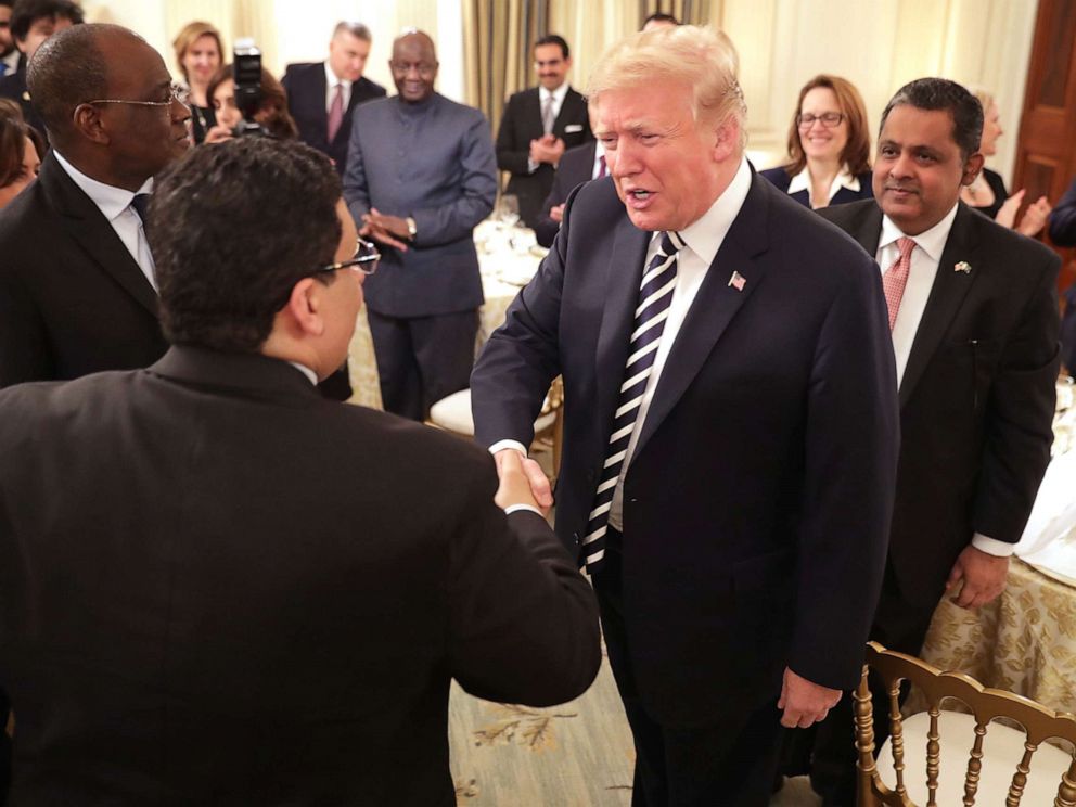 PHOTO: President Donald Trump greets guests while hosting an Iftar dinner in the State Dining Room at the White House, June 6, 2018, in Washington.