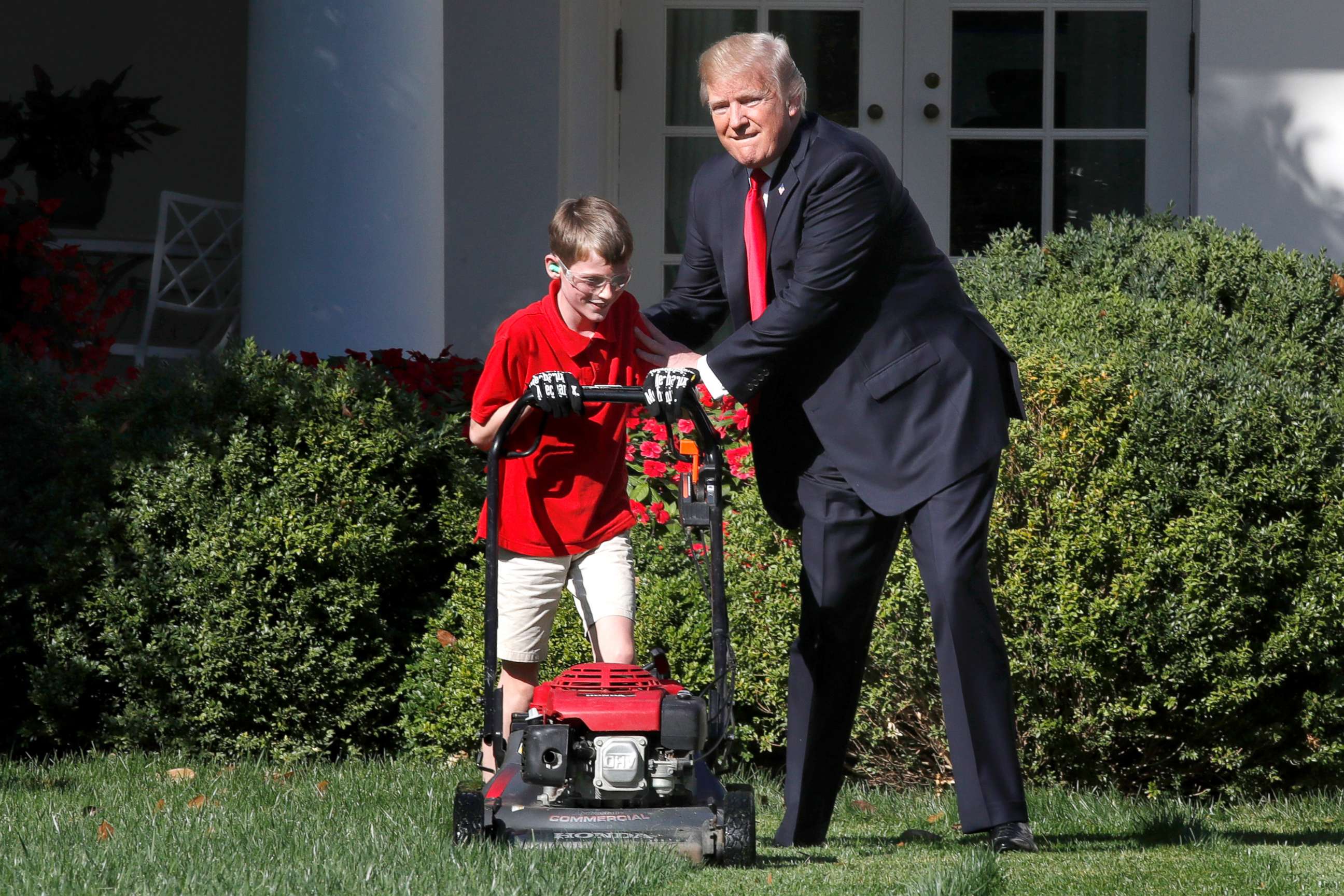 PHOTO: Frank Giaccio, 11, of Falls Church, Va., left, is encouraged by President Donald Trump, Sept. 15, 2017, while he mowed the lawn in the Rose Garden at the White House in Washington.