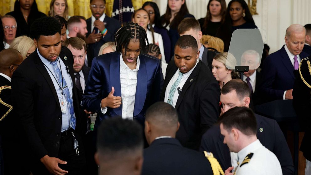 PHOTO: Louisiana State University team member Sa'Myah Smith flashes a thumbs-up after collapsing during a celebration of the team's NCAA Division I women's basketball national championship in the East Room of the White House on May 26, 2023.