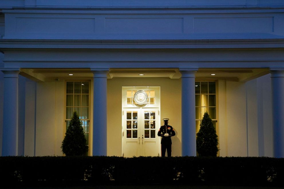 PHOTO: A Marine stands outside the West Wing of the White House at dusk after the House of Representatives voted to impeach President Donald Trump on Jan. 13, 2021, in Washington, D.C.