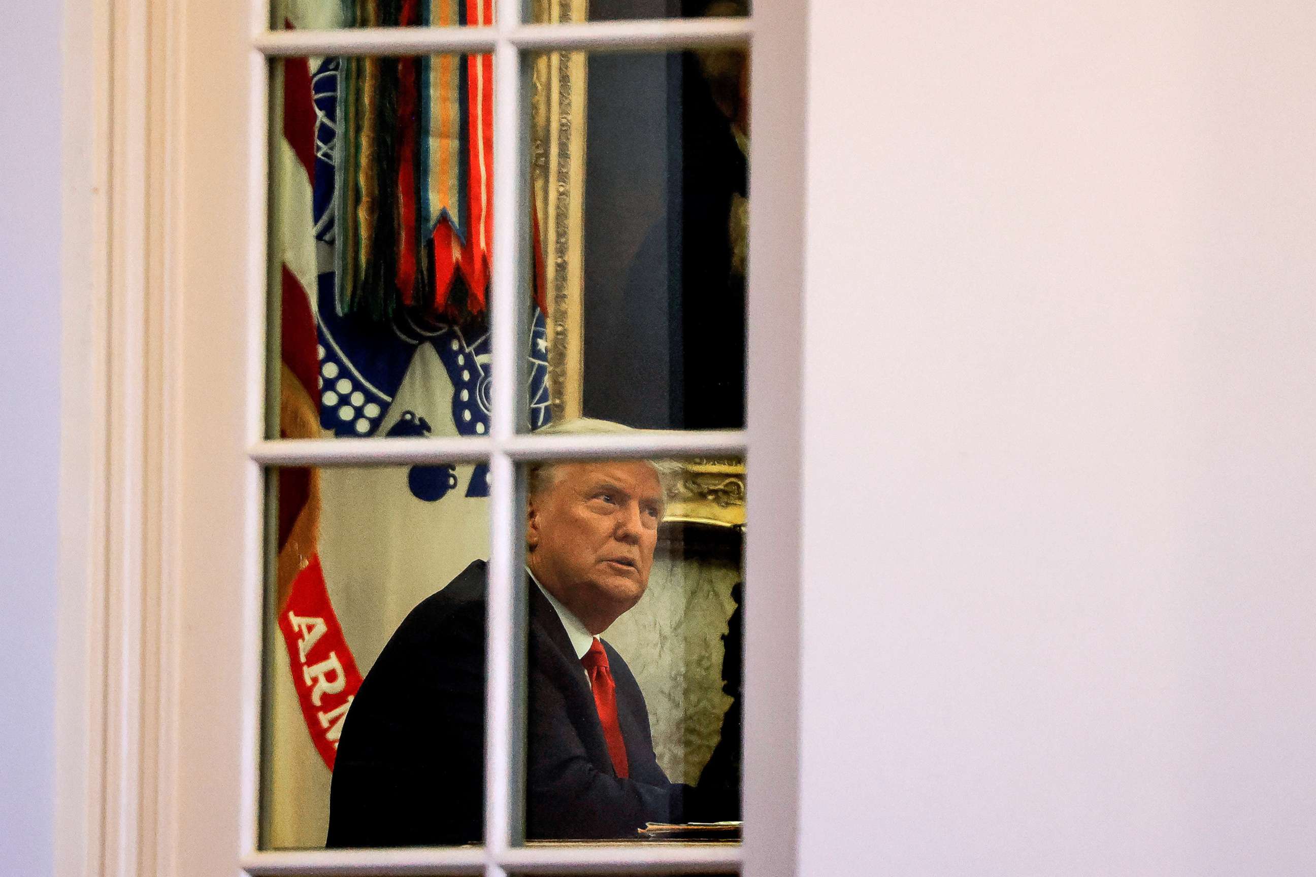 PHOTO: President Donald Trump sits in the Oval Office of the White House in Washington, Nov. 13, 2020.