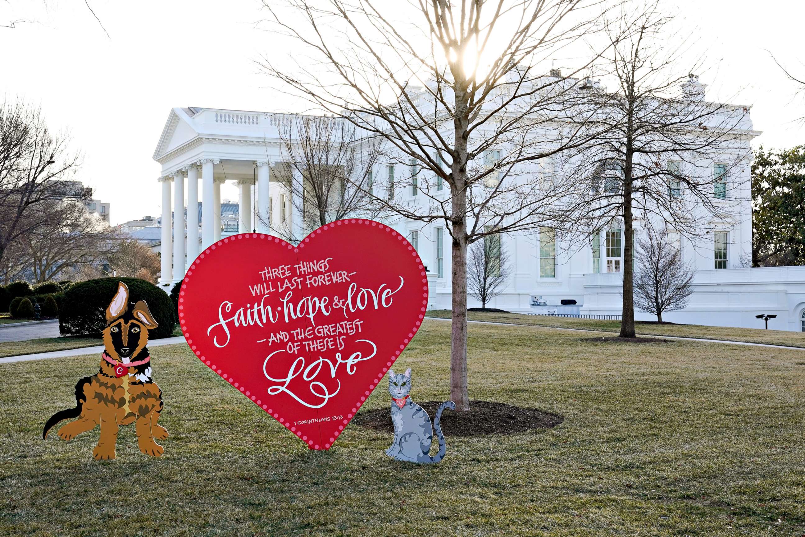 PHOTO: A Valentine's heart and depictions of President Joe Biden and first lady Jill Biden's new dog Commander, left, and cat Willow, stand on the North Lawn of the White House in celebration of Valentine's Day, Feb. 14, 2022, in Washington.