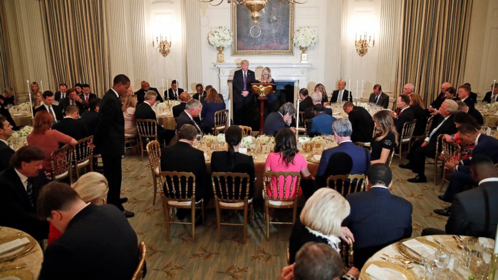PHOTO: President Donald Trump bows his head in prayer as pastor Paula White leads the room in prayer during a dinner for evangelical leaders in the State Dining Room of the White House, Monday, Aug. 27, 2018, in Washington.