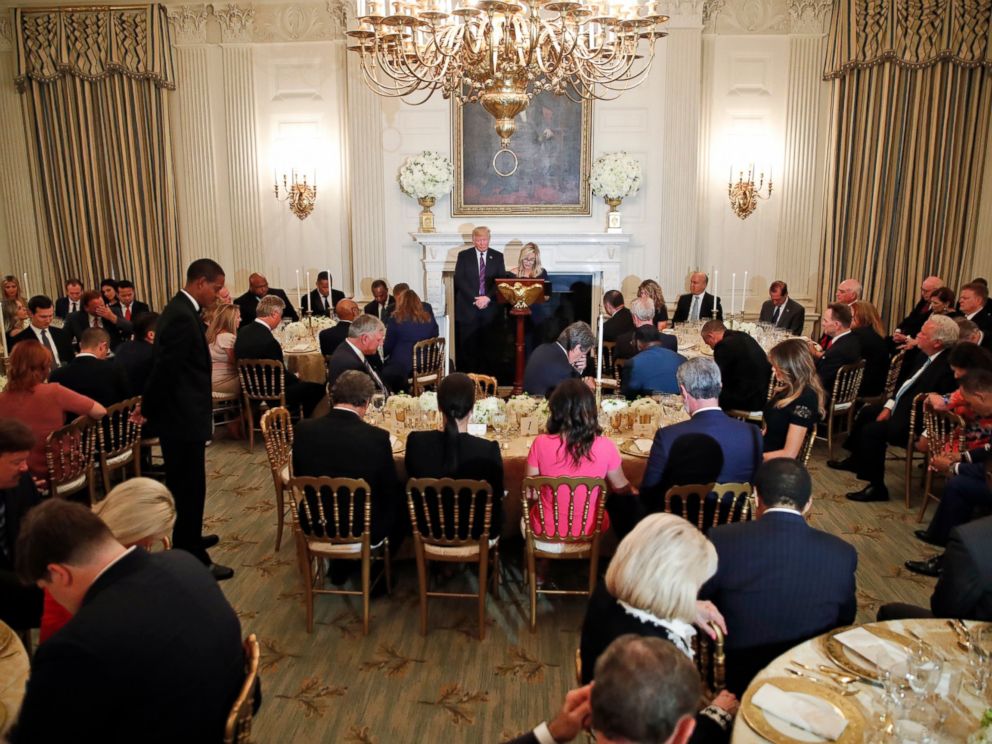 PHOTO: President Donald Trump bows his head in prayer as pastor Paula White leads the room in prayer during a dinner for evangelical leaders in the State Dining Room of the White House, Monday, Aug. 27, 2018, in Washington.