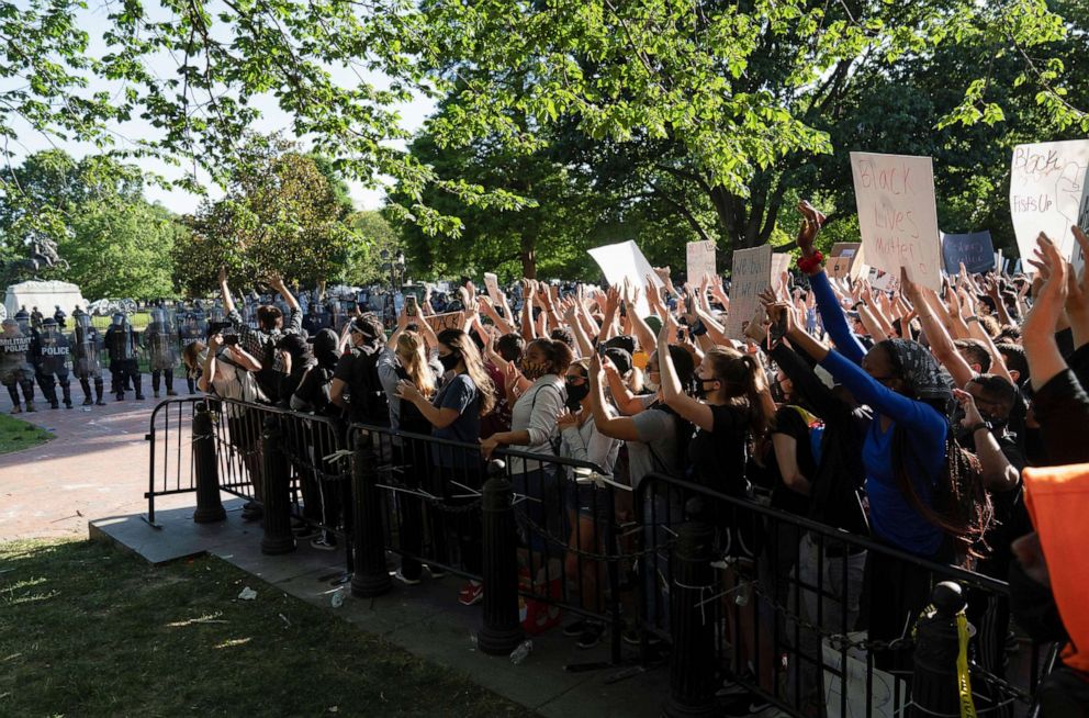 PHOTO: Protestors peacefully protest from a penned in area minutes before riot police moved to clear them out of Lafayette Park and the area around it, June 1, 2020, before President Trump appeared for a photo opportunity nearby.