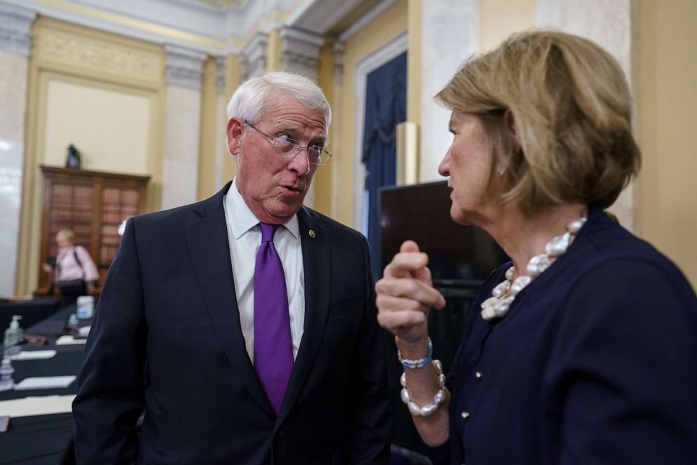 PHOTO: Sen. Roger Wicker and Sen. Shelley Moore Capito, the GOP's lead negotiator on a counteroffer to President Joe Biden's infrastructure plan, confer at a Senate Environment and Public Works Committee markup at the Capitol, May 26, 2021. 