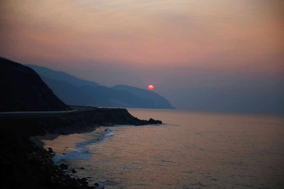 PHOTO: The sun rises over the Pacific Ocean as the Woolsey Fire continues to burn in Malibu, Calif., Nov. 11, 2018.