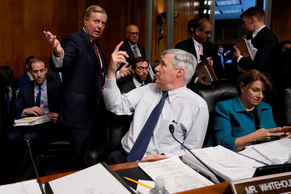 PHOTO: Sen. Lindsay Graham speaks with Sen. Sheldon Whitehouse at a Senate Judiciary Committee hearing where Attorney General William Barr testified on Capitol Hill in Washington, May 1, 2019.