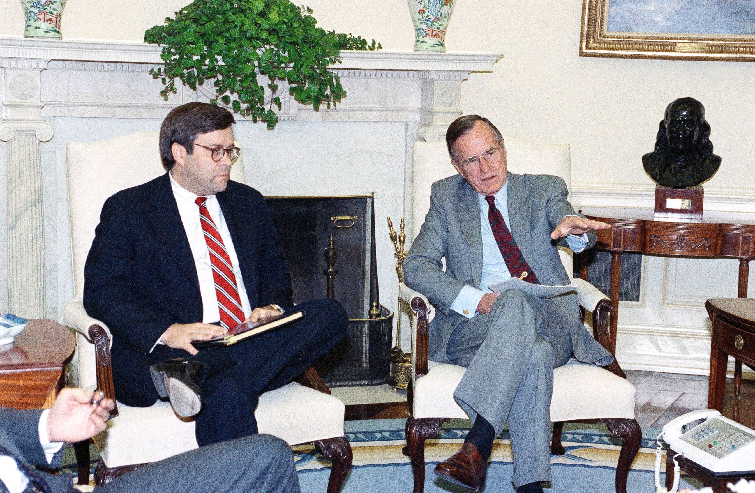 PHOTO: President George H. Bush gestures while talking to Attorney General William Barr in the Oval Office of the White House, May 4, 1992 in Washington.