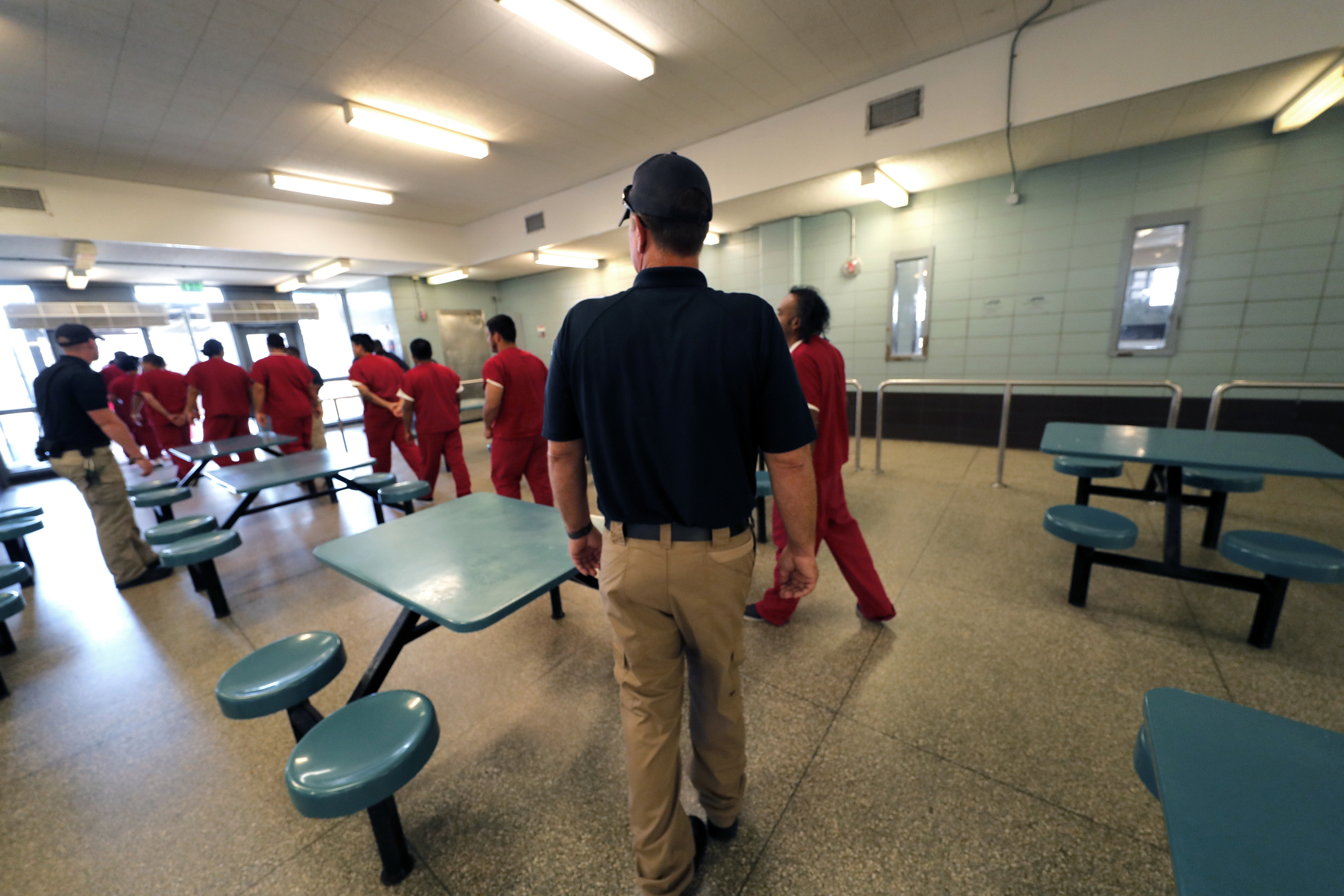 PHOTO: Detainees leave the cafeteria under the watch of guards during a media tour at the Winn Correctional Center in Winnfield, La., Sept. 26, 2019.
