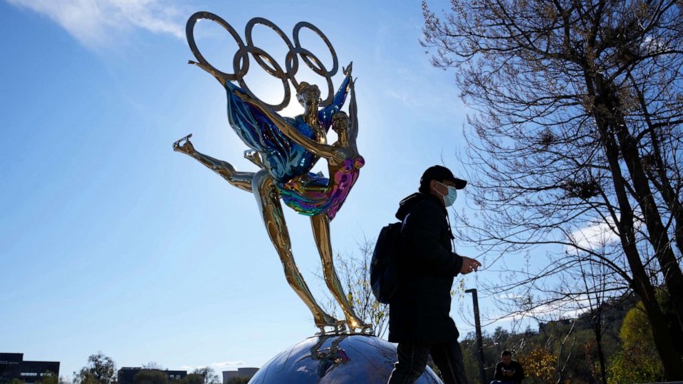 PHOTO: A visitor to the Shougang Park walks past the a sculpture for the Beijing Winter Olympics in Beijing, China, Nov. 9, 2021.