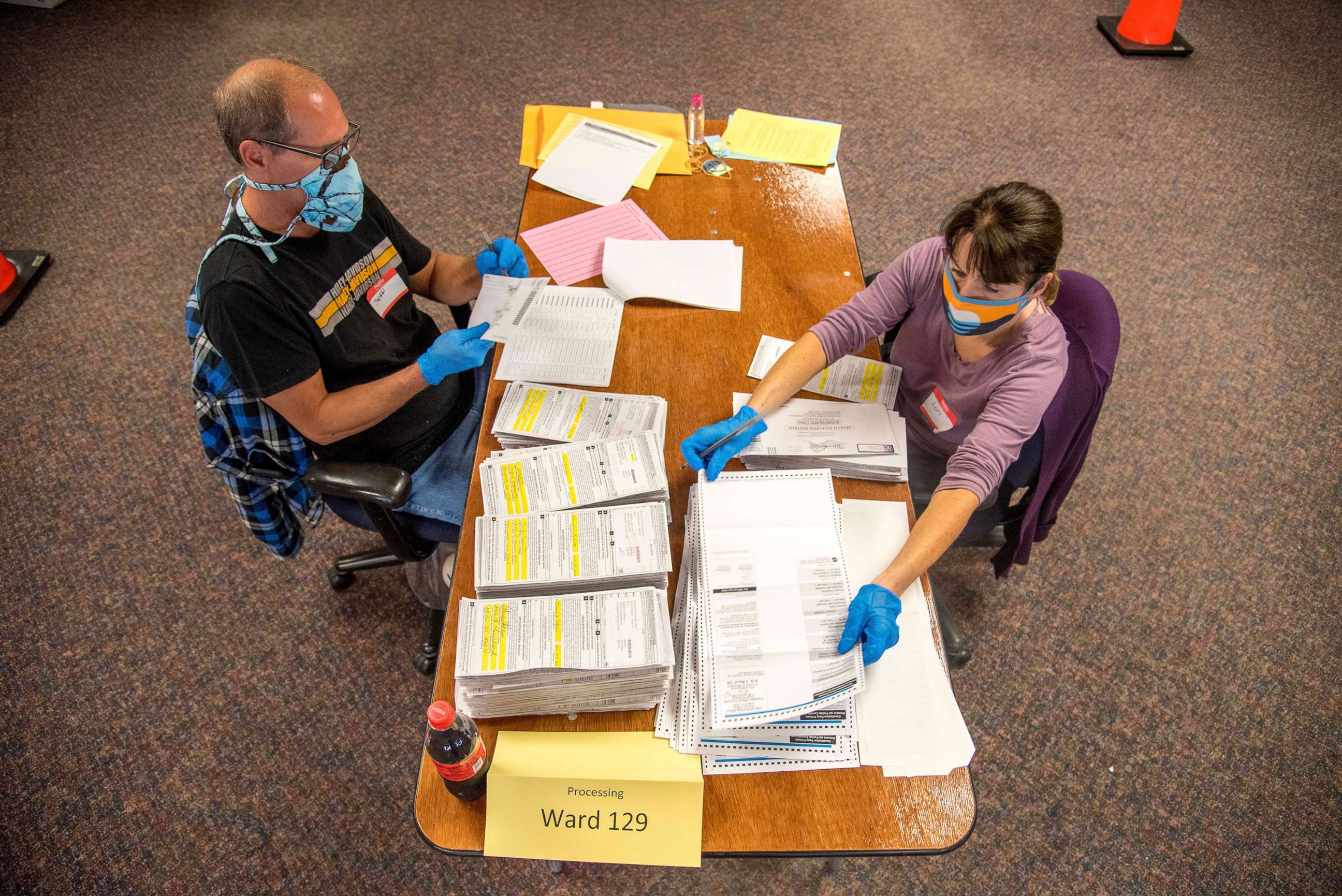 PHOTO: In this photo provided by Wisconsin Watch, election workers Jeff and Lori Lutzka, right, process absentee ballots at Milwaukee's central count facility on Aug. 11, 2020.