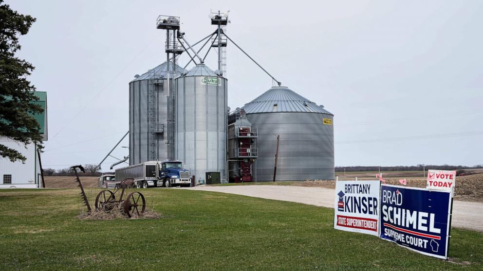 PHOTO: Signs supporting Brad Schimel for Wisconsin Supreme Court and Brittany Kinser for Wisconsin Superintendent of Public Instruction adorn the lawn of a farm along County Road A on Election Day, April 1, 2025, near Tibbets, Wis.