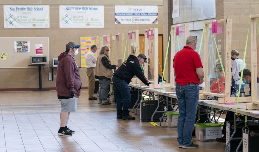 PHOTO: People check in to vote at a polling location, April 7, 2020, in Sun Prairie, Wisconsin.
