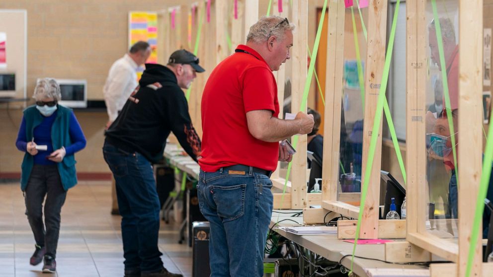 PHOTO: People check in to vote at a polling place on April 7, 2020, in Sun Prairie, Wisconsin.