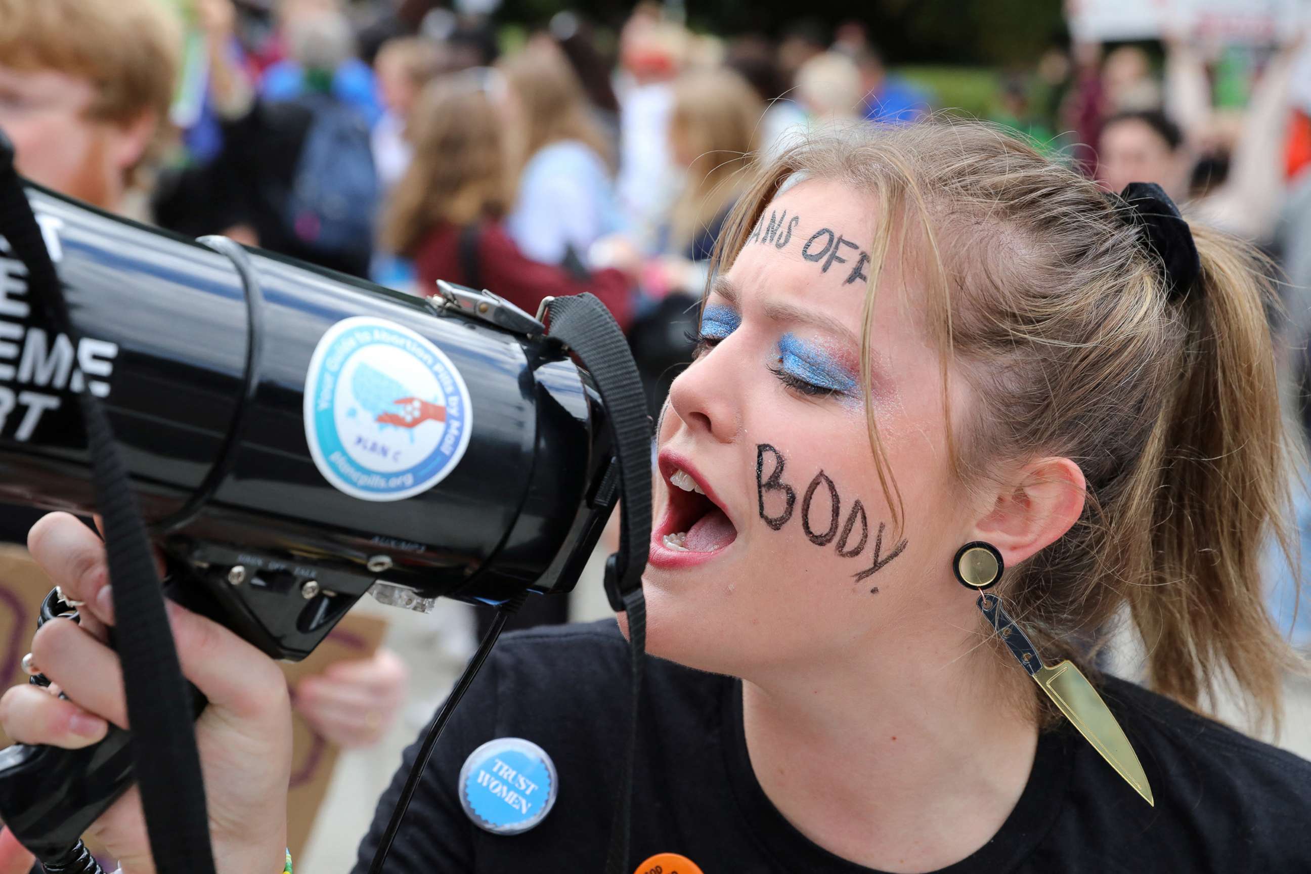 PHOTO: Allison Bucy yells into a bullhorn during the 2022 Women's March with the theme "We Demand Our Rights" in anticipation of the upcoming U.S. midterm elections on Capitol Hill in Washington, Oct. 8, 2022.