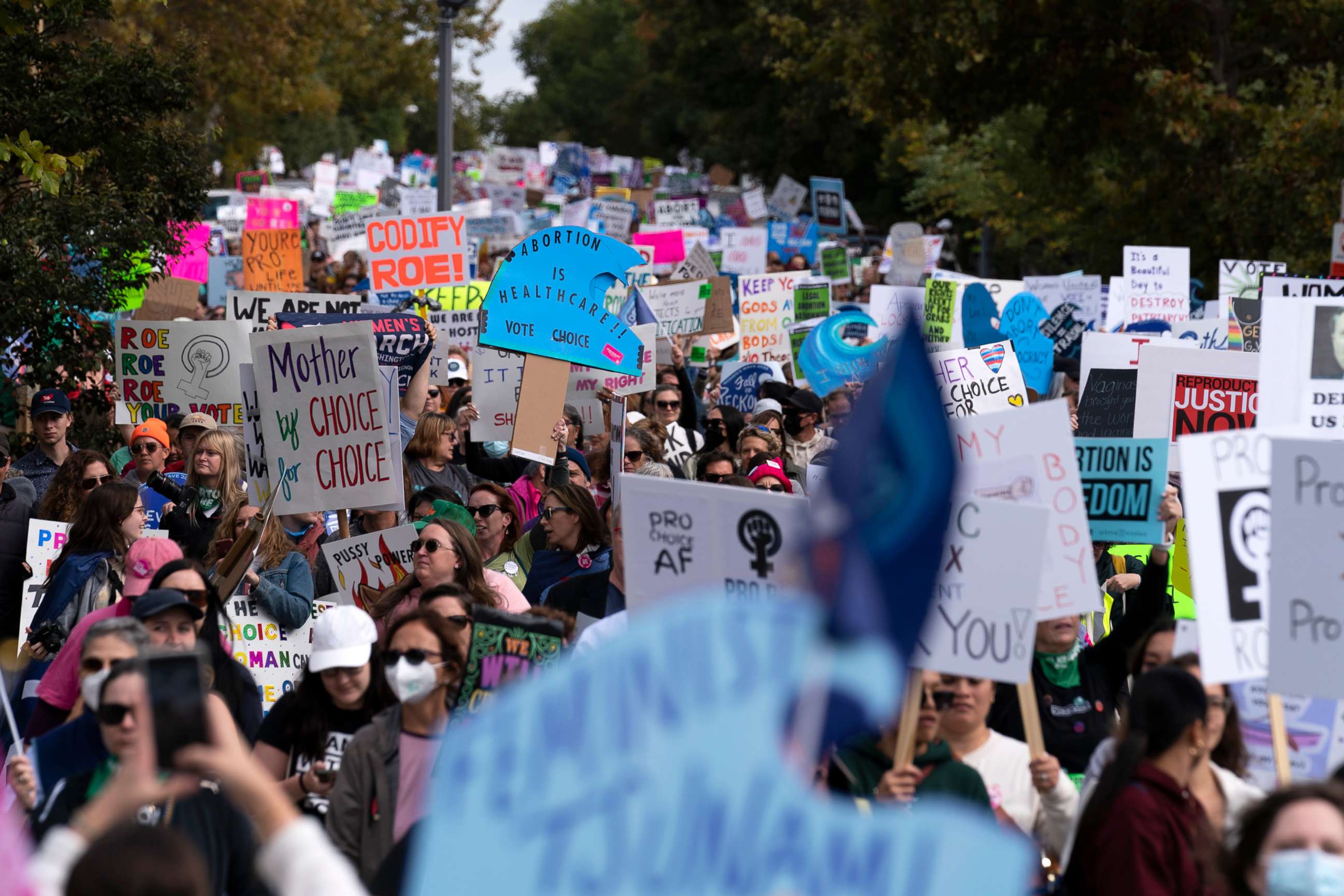 PHOTO: Demonstrators hold signs as they rally during the Women's March in Washington,  Oct. 8, 2022.