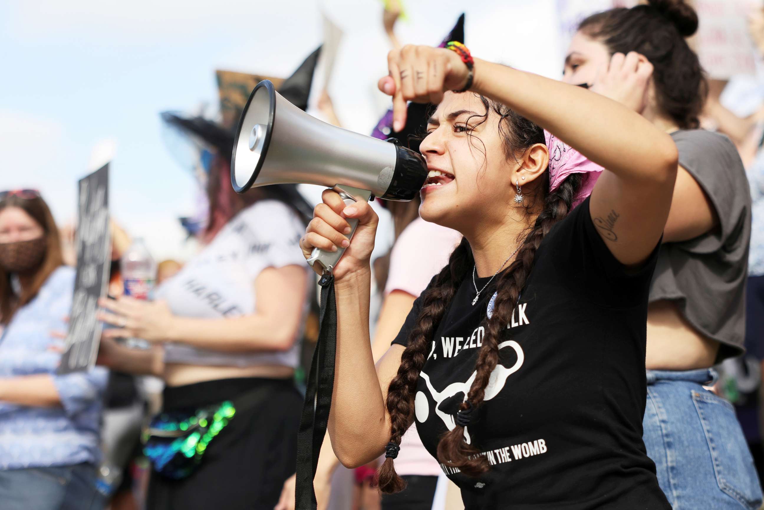 PHOTO: Lexi, 22, speaks on a megaphone as women's rights advocates participate in the nationwide Women's March in Austin, Texas, Oct. 2, 2021. 