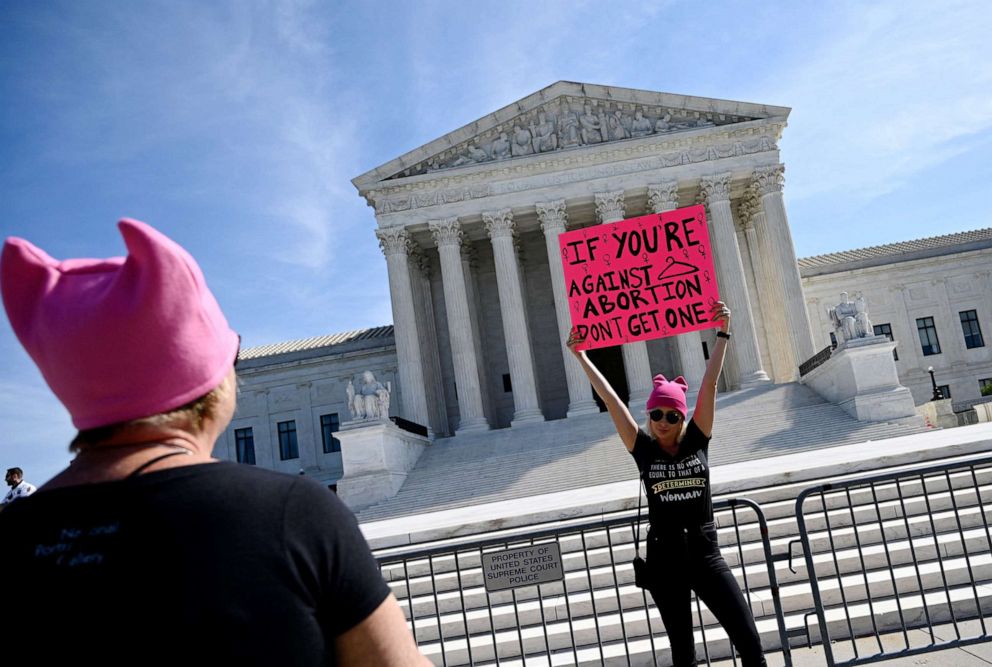 PHOTO: Protesters hold signs in front of the Supreme Court during the Women's March and Rally for Abortion Justice in Washington, Oct. 2, 202