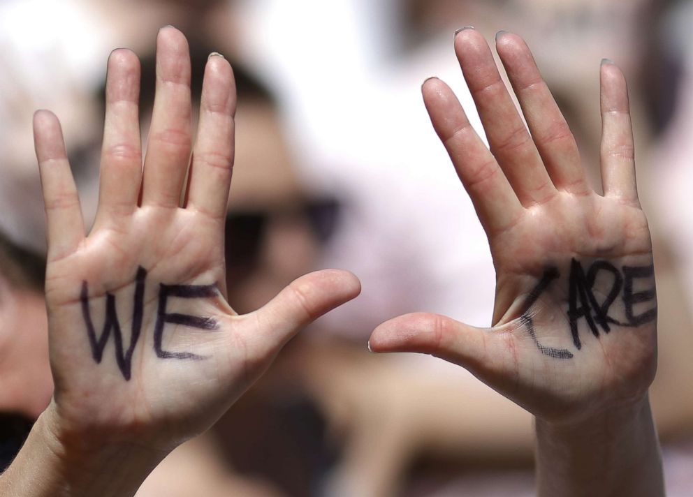 PHOTO: 'We Care' is written on a protester's hands during a march from Freedom Plaza to demonstrate against family detentions and to demand the end of criminalizing efforts of asylum seekers and immigrants June 28, 2018 in Washington, D.C.