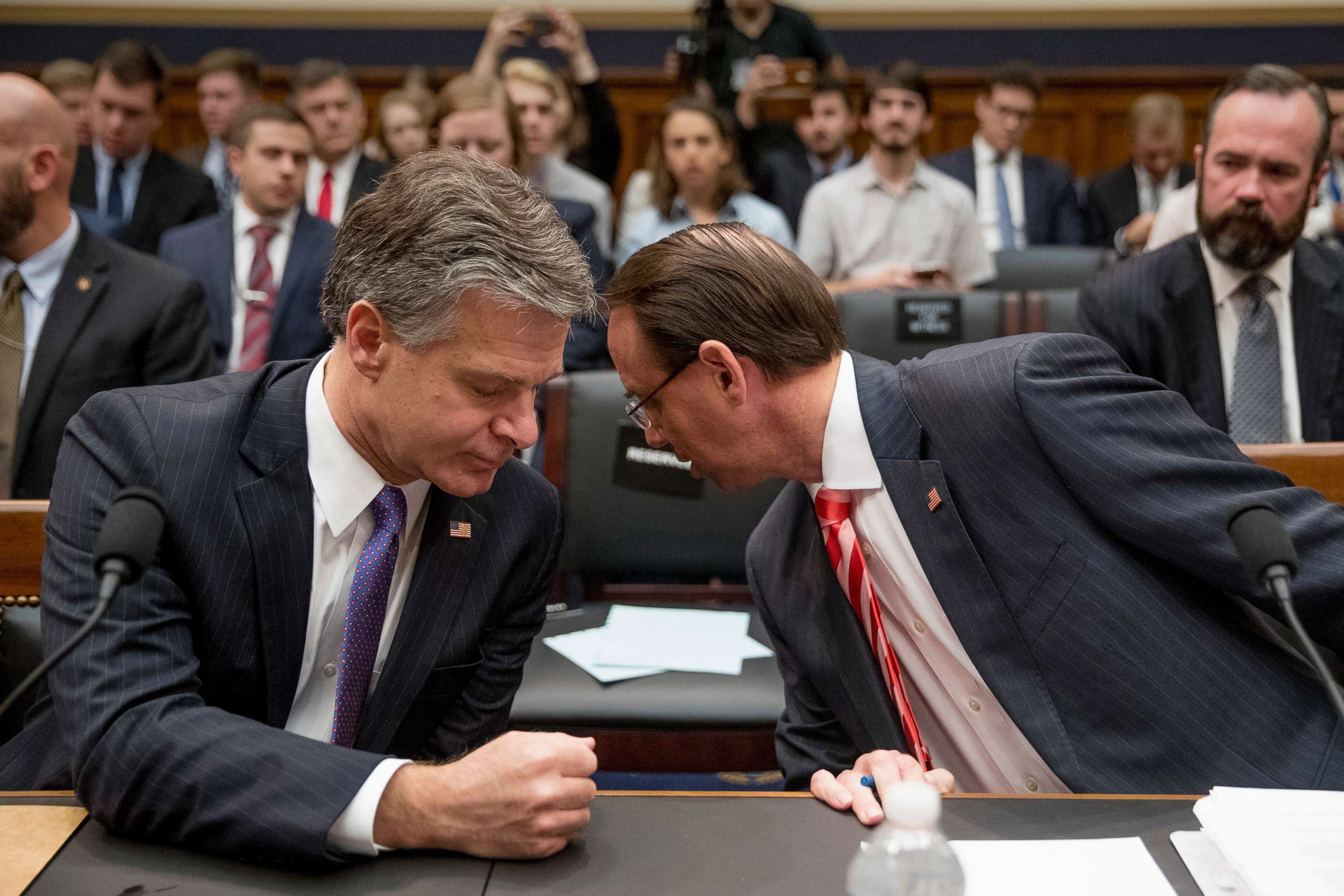 PHOTO: FBI Director Christopher Wray, left, speaks with Deputy Attorney General Rod Rosenstein during the start of the hearing on the Justice Department and FBI actions around the 2016 presidential election, June 28, 2018, in Washington, D.C.