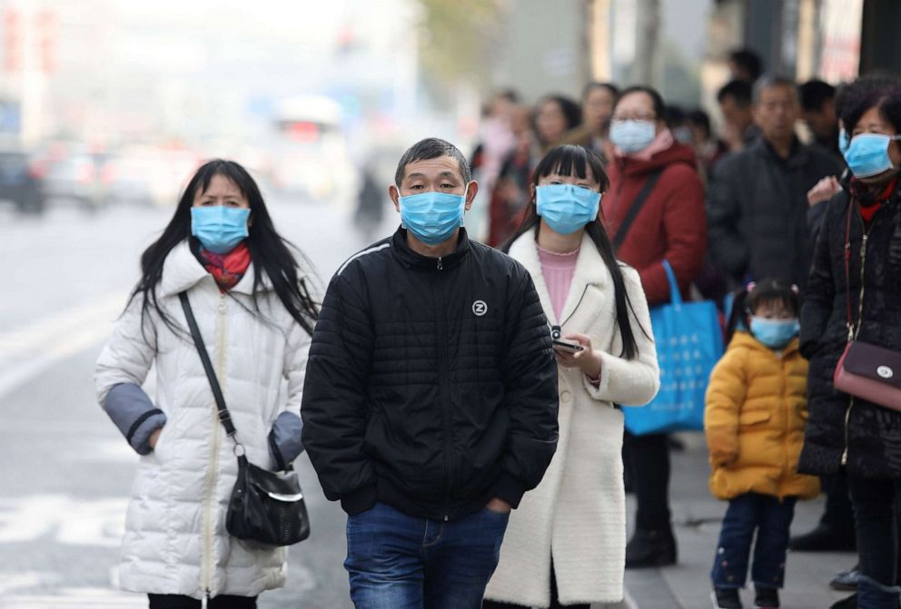 PHOTO: In this Jan. 20, 2020, file photo, Chinese residents wear masks while waiting at a bus station near the closed Huanan Seafood Wholesale Market, in Wuhan, Hubei province, China.