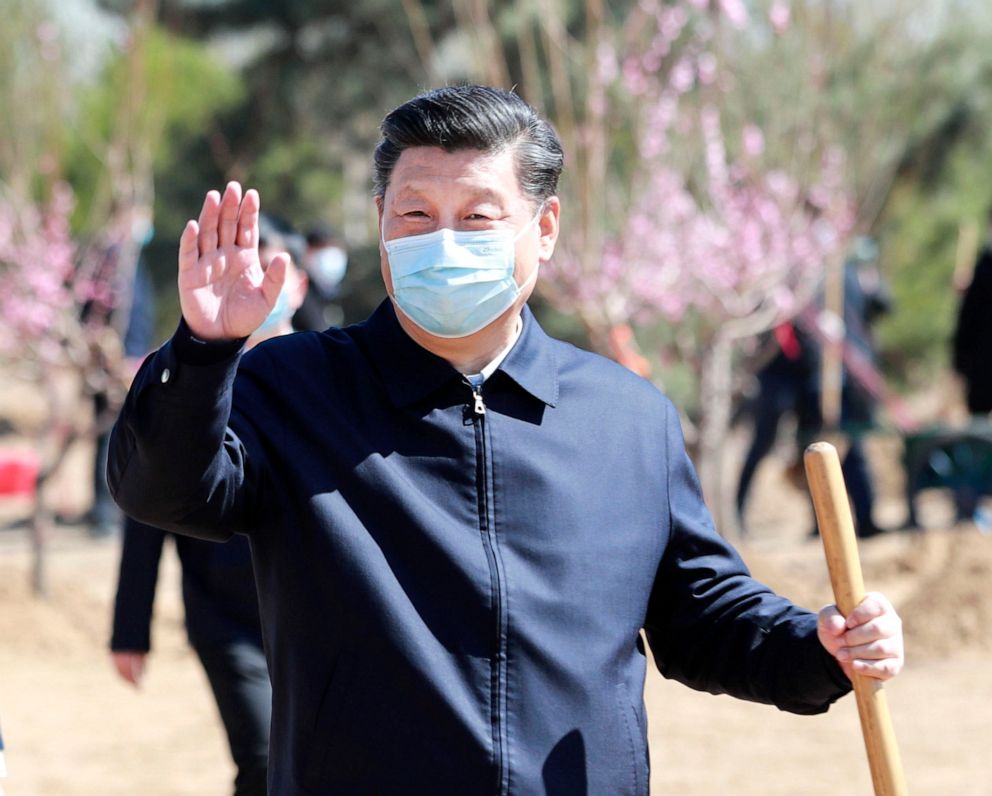 PHOTO: Chinese President Xi Jinping waves to officials and people on-site during a voluntary tree-planting activity in Daxing District in Beijing, China, April 3, 2020. 