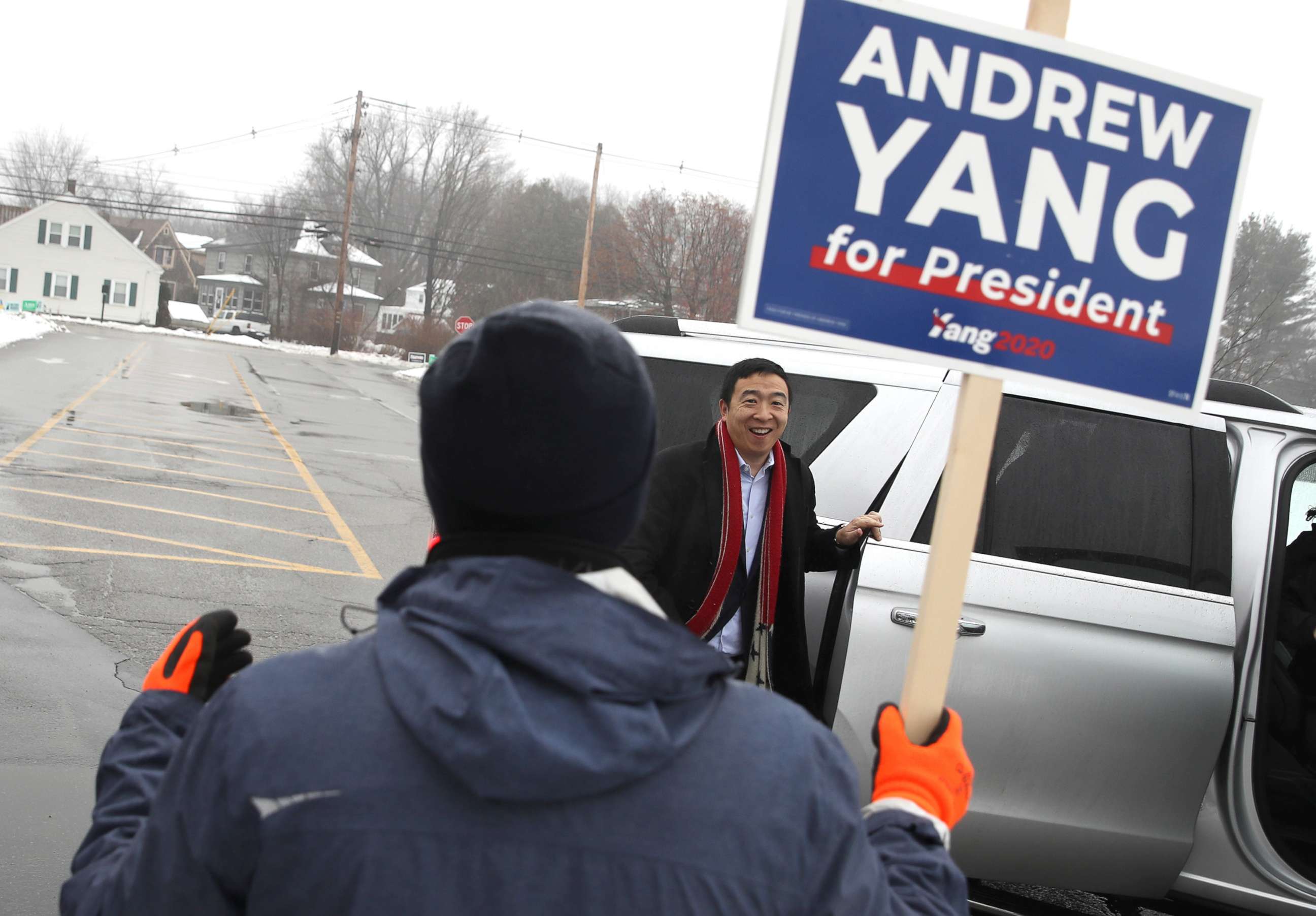 PHOTO: Democratic presidential candidate Andrew Yang greets a supporters who is holding a campaign sign in front of a polling station, Feb. 11, 2020, in Keene, N.H.