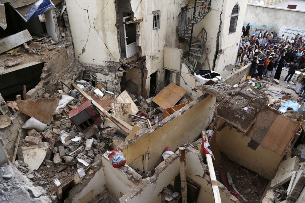 PHOTO: People are seen near houses a day after they were hit by airstrikes carried out by the Saudi-led coalition that left a reported six people killed and more than 40 others injured including children and women on May 17, 2019, in Sana'a, Yemen.