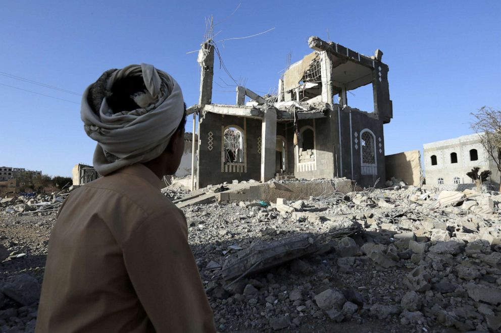 PHOTO: A Yemeni man sits in front of a building allegedly destroyed by recent airstrikes in Sana'a, Yemen, March 25, 2018.