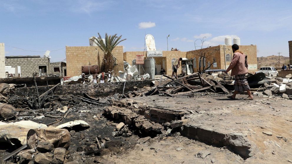 A man walks at the scene of an air strike that hit a gas station near a hospital in Kutaf district of the northwestern province of Saada, Yemen, March 28, 2019.
