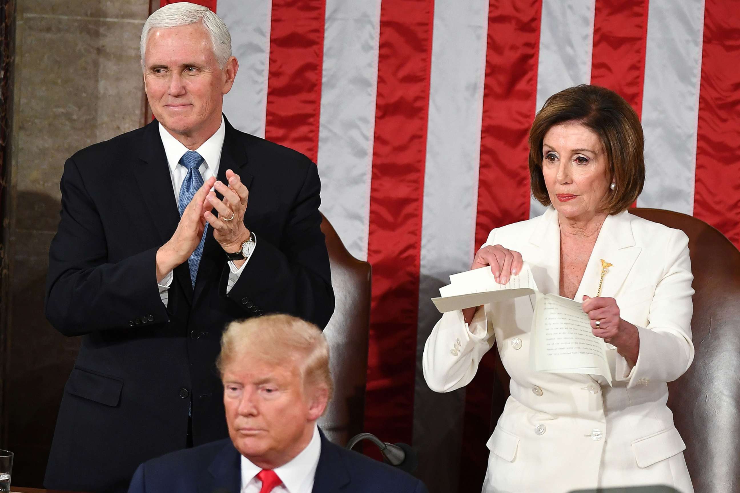 PHOTO: Vice President Mike Pence claps as Speaker of the House of Representatives Nancy Pelosi rips a copy of President Donald Trump's speech after he delivered the State of the Union address at the U.S. Capitol in Washington, D.C., Feb. 4.