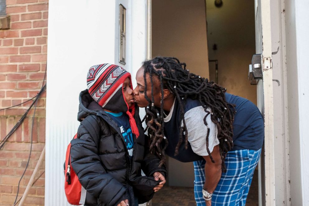 PHOTO: U.S. federal government contractor Yvette Hicks gives her son a kiss goodbye as he heads to school on the 35th day of the partial federal government shutdown in Washington, Jan. 25, 2019.