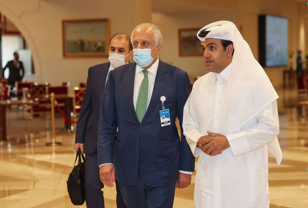 PHOTO: U.S. special envoy for Afghanistan Zalmay Khalilzad and Qatar's envoy on counter-terrorism Mutlaq al-Qahtani walk down a hotel lobby in Qatar's capital Doha during an international meeting on the escalating conflict in Afghanistan, Aug. 10, 2021.