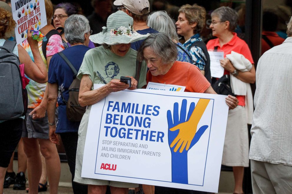 PHOTO: Two women hold a sign at a rally near Philadelphia's Immigration and Customs Enforcement office, organized by the ACLU in opposition to policies which separate children from their families when entering the U.S. illegally, June 1, 2018.