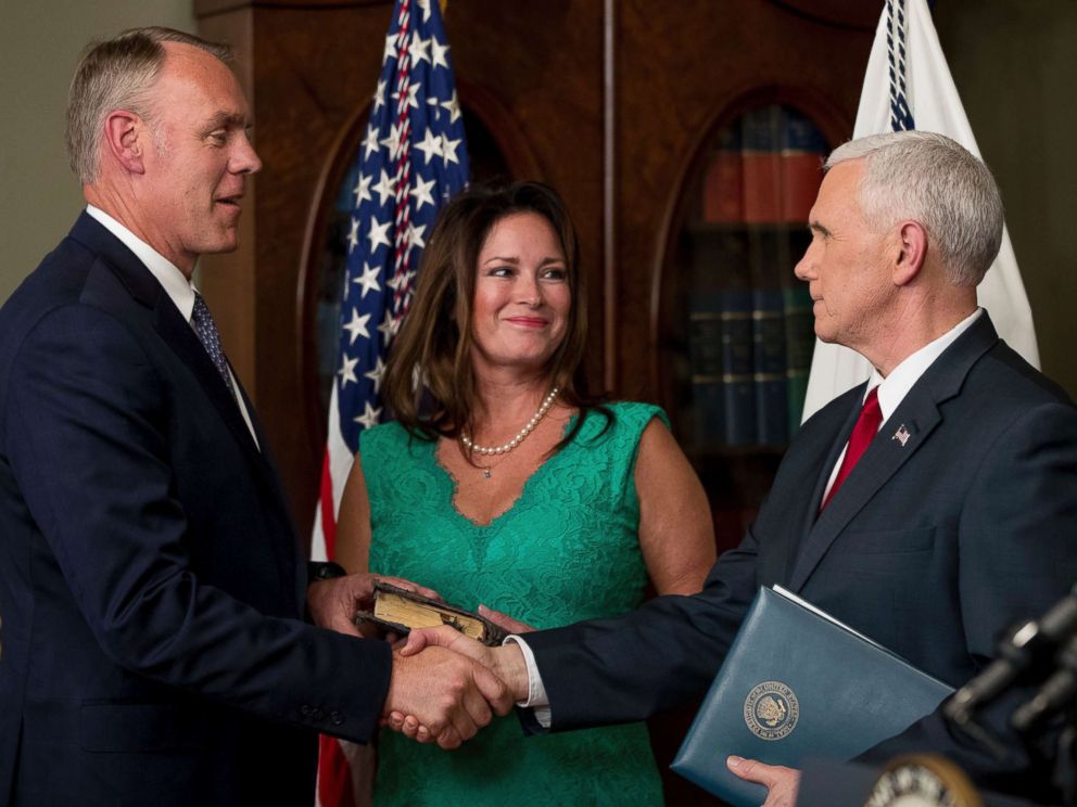 PHOTO: Vice President Mike Pence, right, shakes hands after administering the oath of office to Interior Secretary Ryan Zinke, left, with his wife Lolita Hand, center, March 1, 2017, in the Eisenhower Executive Office Building on the White House complex. 