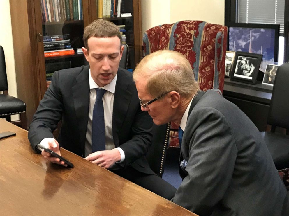 PHOTO: Facebook CEO Mark Zuckerberg holds a mobile phone while speaking with Senator Bill Nelson in the Hart Senate Office Building in Washington, April 9, 2018.