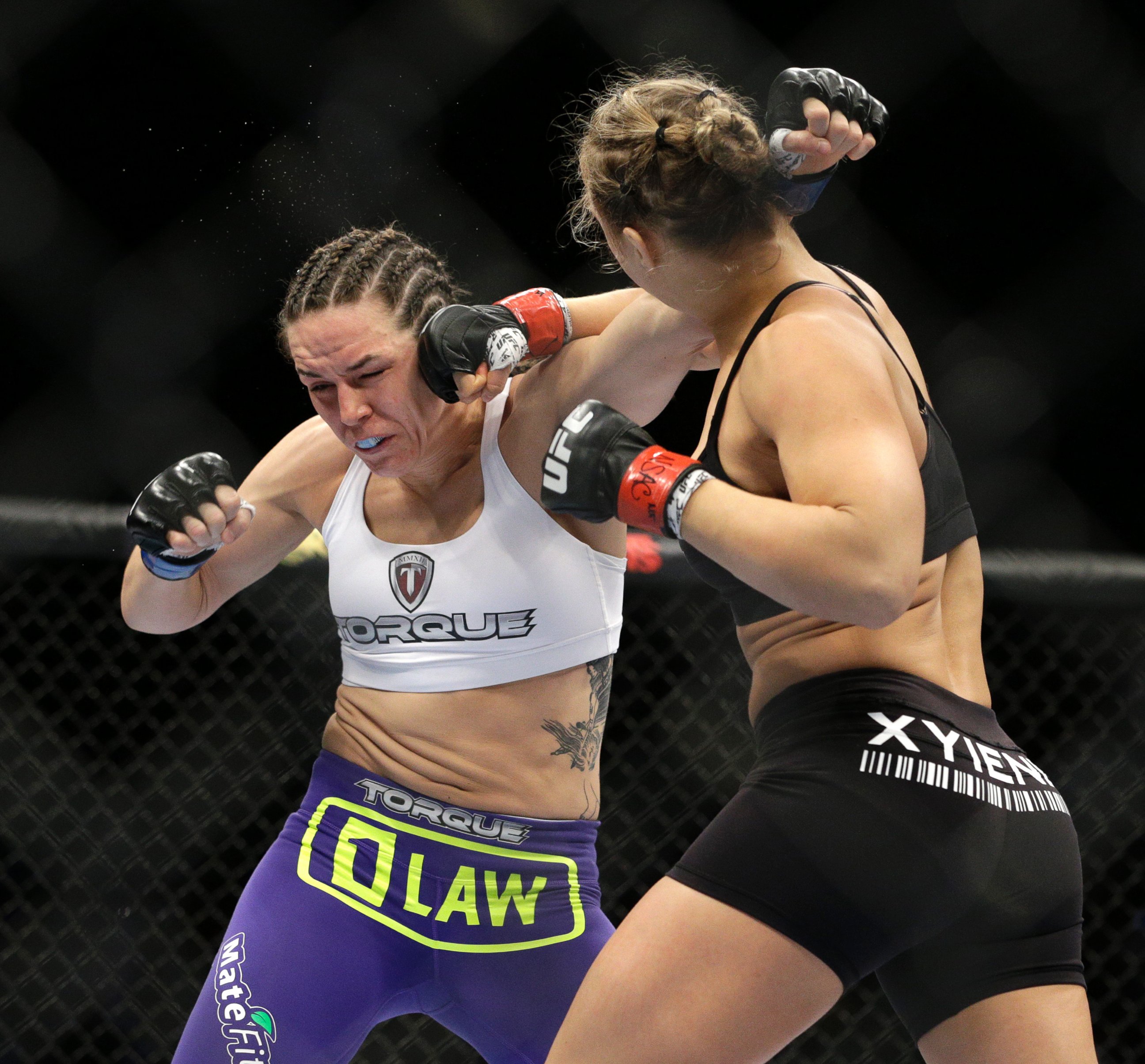 PHOTO: Ronda Rousey hits Alexis Davis during their women's mixed martial arts bantamweight title bout at UFC 175, July 5, 2014, in Las Vegas. 