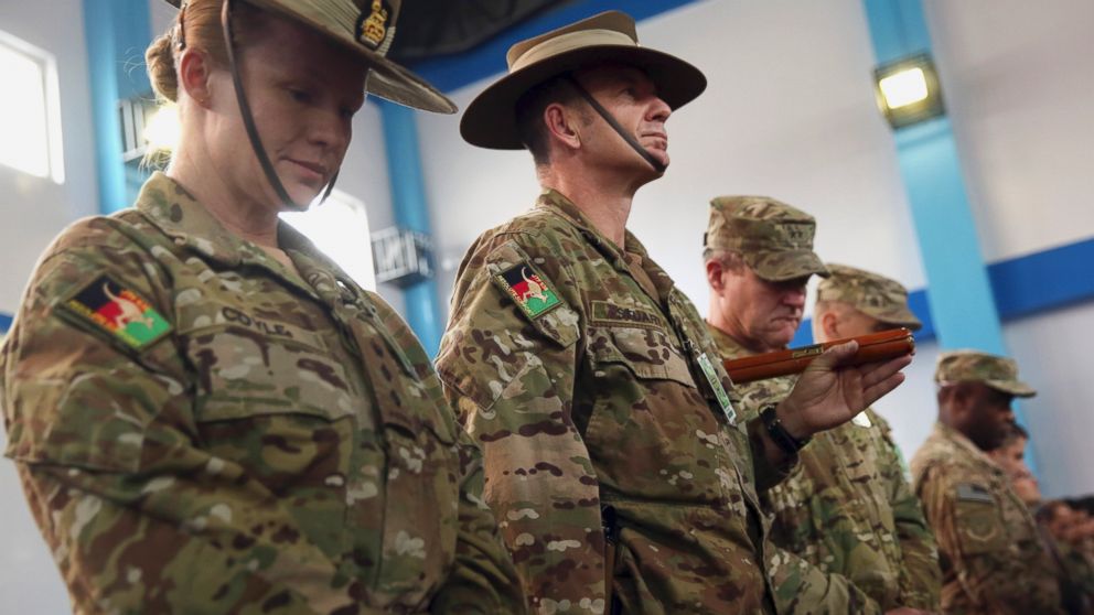 Soldiers for the International Security Assistance Force (ISAF) attend a ceremony at the ISAF headquarters in Kabul, Afghanistan, Dec. 28, 2014. 