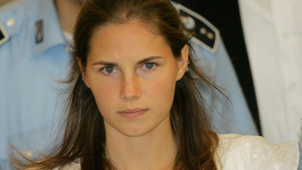 Amanda Knox is escorted by Italian penitentiary police officers from Perugia's court after a hearing, Sept. 16, 2008.